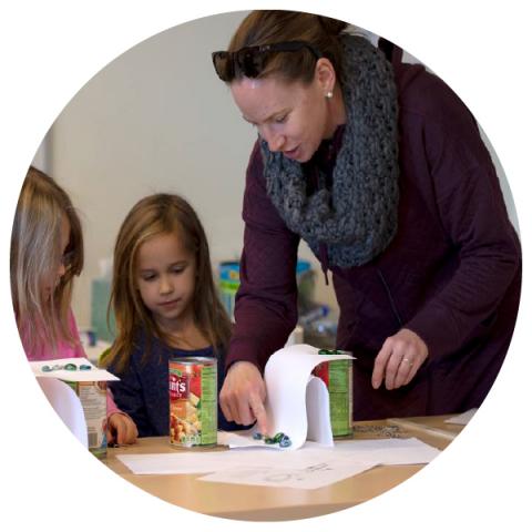 A STEM volunteer helping kids