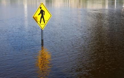 flooded road with pedestrian sign -  istock image
