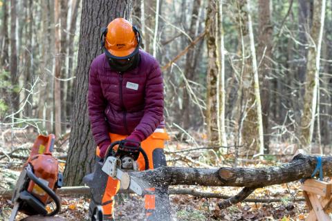participant operating a chainsaw