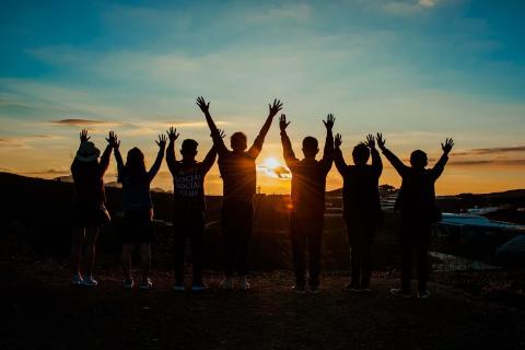 Group of youth enjoying a sunrise.