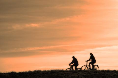 Two people riding bikes