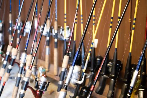 Detailed picture of fishing rods leaning against a wall.