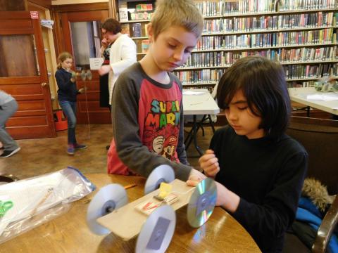 youth working on a mousetrap car