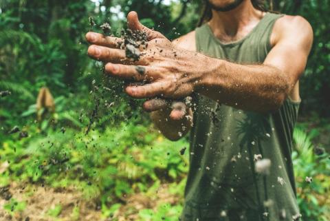 Man cleaning soil off hands