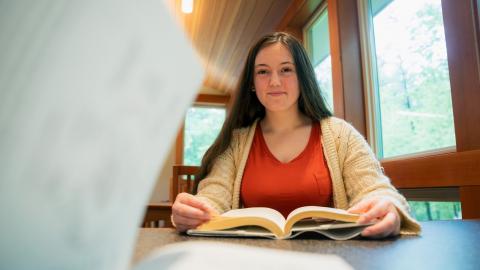 Summer intern reading a book