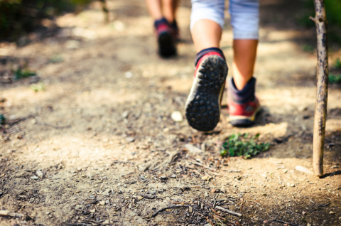 hikers feet on a dirt trail