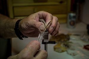 A Hand Tying a Fly for Fishing