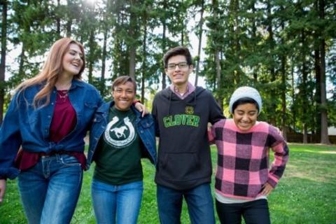 Photo of teens standing together, smiling