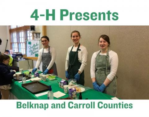 Image of three girls smiling, they are each wearing aprons. In front of them is a table with cooking materials and a green tablecloth.