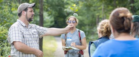 mike gagnon, county forester showing people an invasive plant