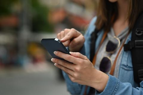 Female person with cell phone in hand