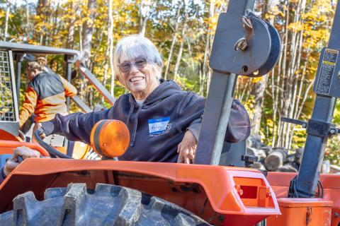 woman sitting on a tractor smiling