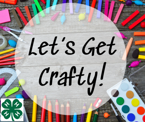 Let's get crafty sign with colored paint and crayons in the background