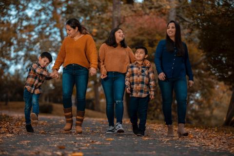 Parents and children out for a walk in the fall.