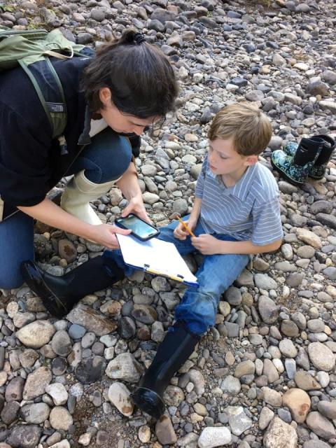 Adult and child making observations in the field
