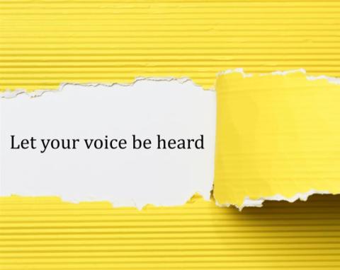 yellow paper that says "let your voice be heard"