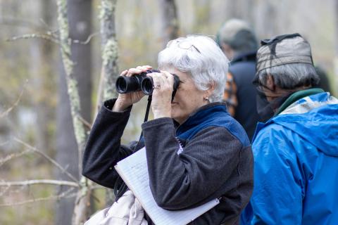 participant looking through binoculars 