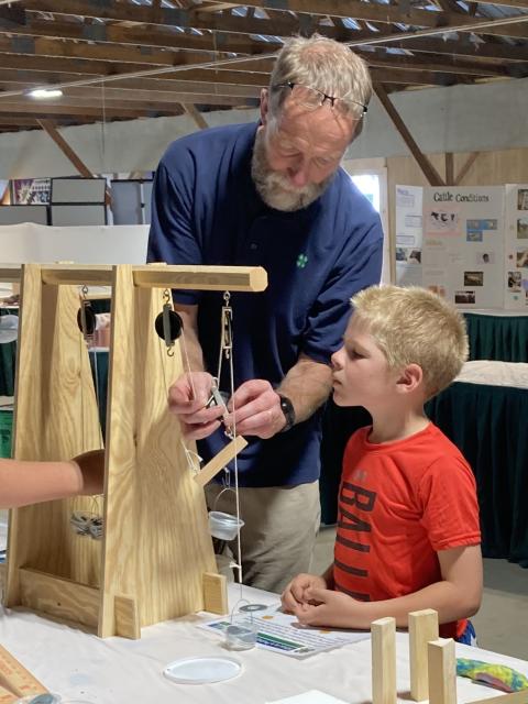 Educator works with youth exploring science