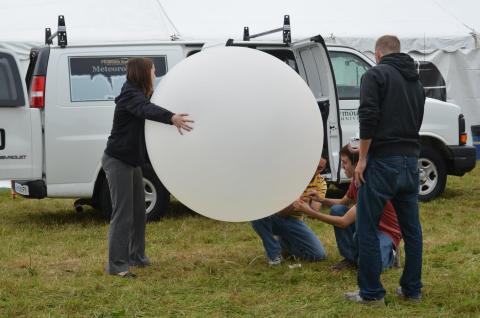 People launching weather balloon