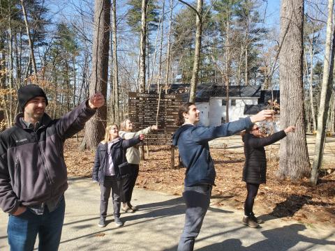 Adults measuring a tree