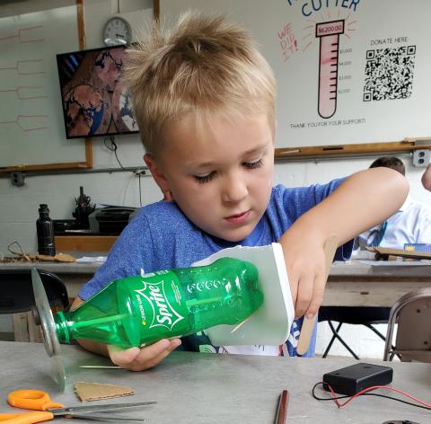 4-H youth building a Scrappy Bot, a simple robot made of recycled materials