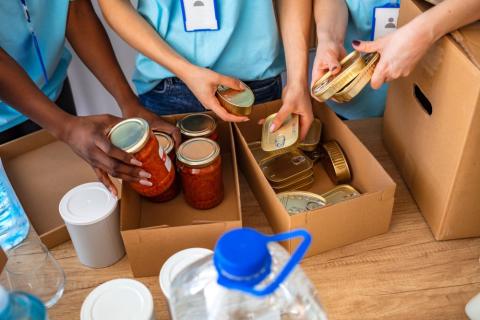 people packing boxes of donated food