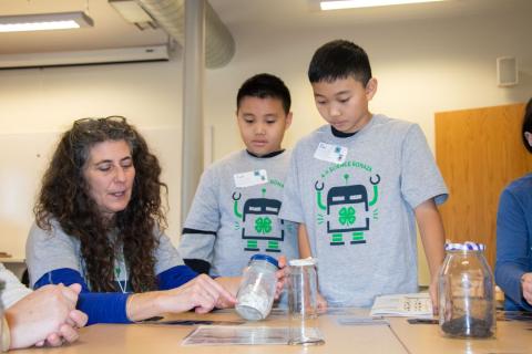 Two boys learning about STEM from 4-H volunteer