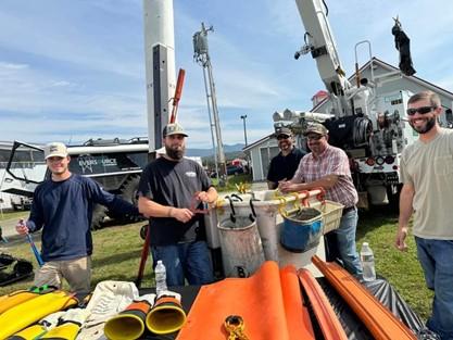 5 Eversource workers with their truck and work equipment