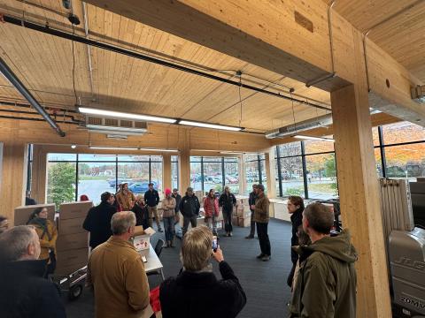 a group of participants standing in a building made of cross laminate timber