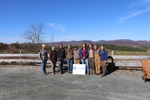 Women posing outside with UNH Extension sign