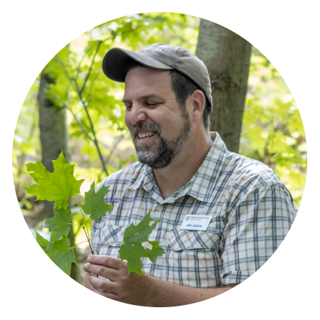 mike gagnon laughing holding tree leaf