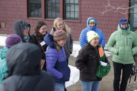 a group of women standing outside laughing