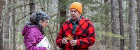 Dode Gladders talking to a landowner in the woods