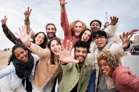 Big group of cheerful young friends taking selfie portrait.