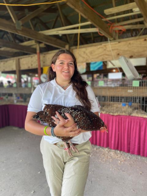Girl holding a chicken