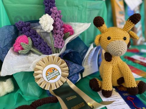 Crochet items with a rosette prize at a 4H exibit