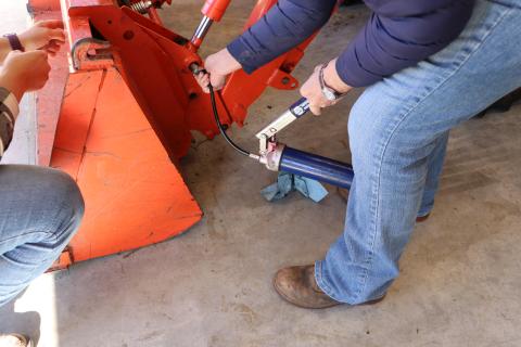 woman fixing tractor