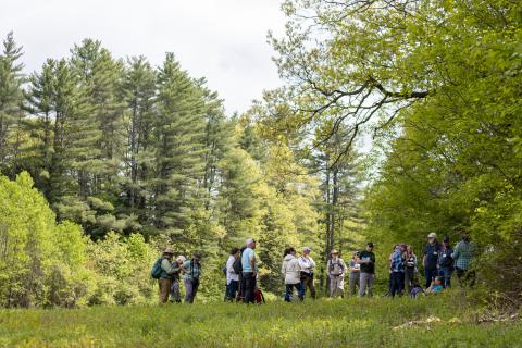 A group of 23 volunteers standing in a field