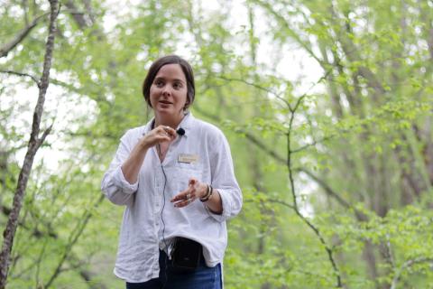 Haley Andreozzi speaking in front of a group of volunteers