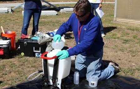 Man filling a backpack sprayer