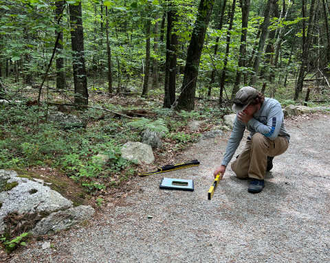 person measuring trail