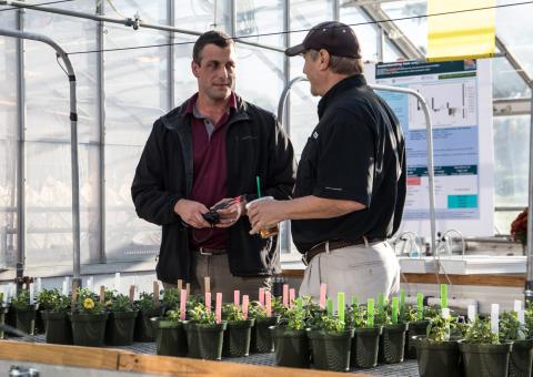 Extension specialist Ryan Dickson chats with members of the Floriculture Research Alliance at a recent open house in October.