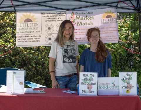 Volunteers pose at the Granite State Market Match booth at the Littleton Farmers Market