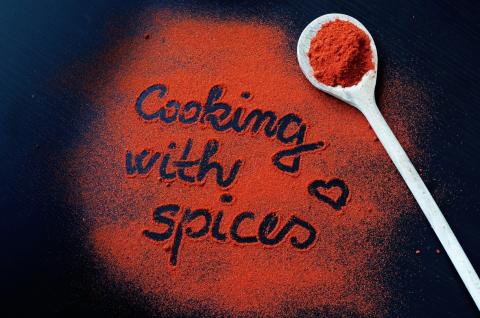 All purpose seasoning blend spread out with message that says cooking with spices.