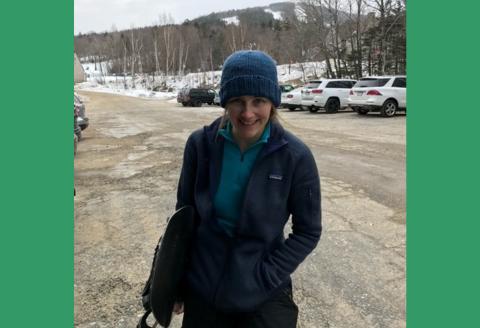 Amanda Royce standing in parking lot in front of mountain