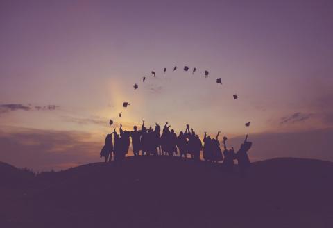 Graduates throwing caps in the air