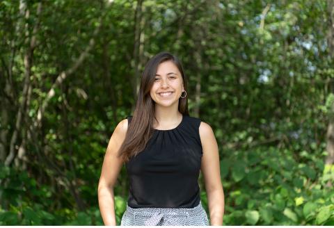 Hannah Arroyo poses in front of trees