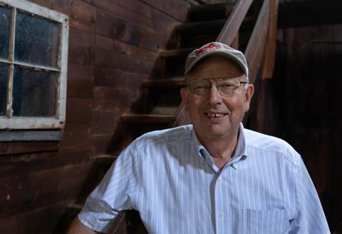 John Porter poses in an old barn