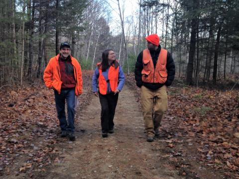 Karen Bennett (middle) walks with consulting forester Charlie Moreno (left) and extension specialist Andy Fast (right) on a dirt road