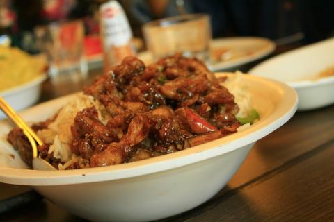 Bowl of rice with chicken and vegetables.